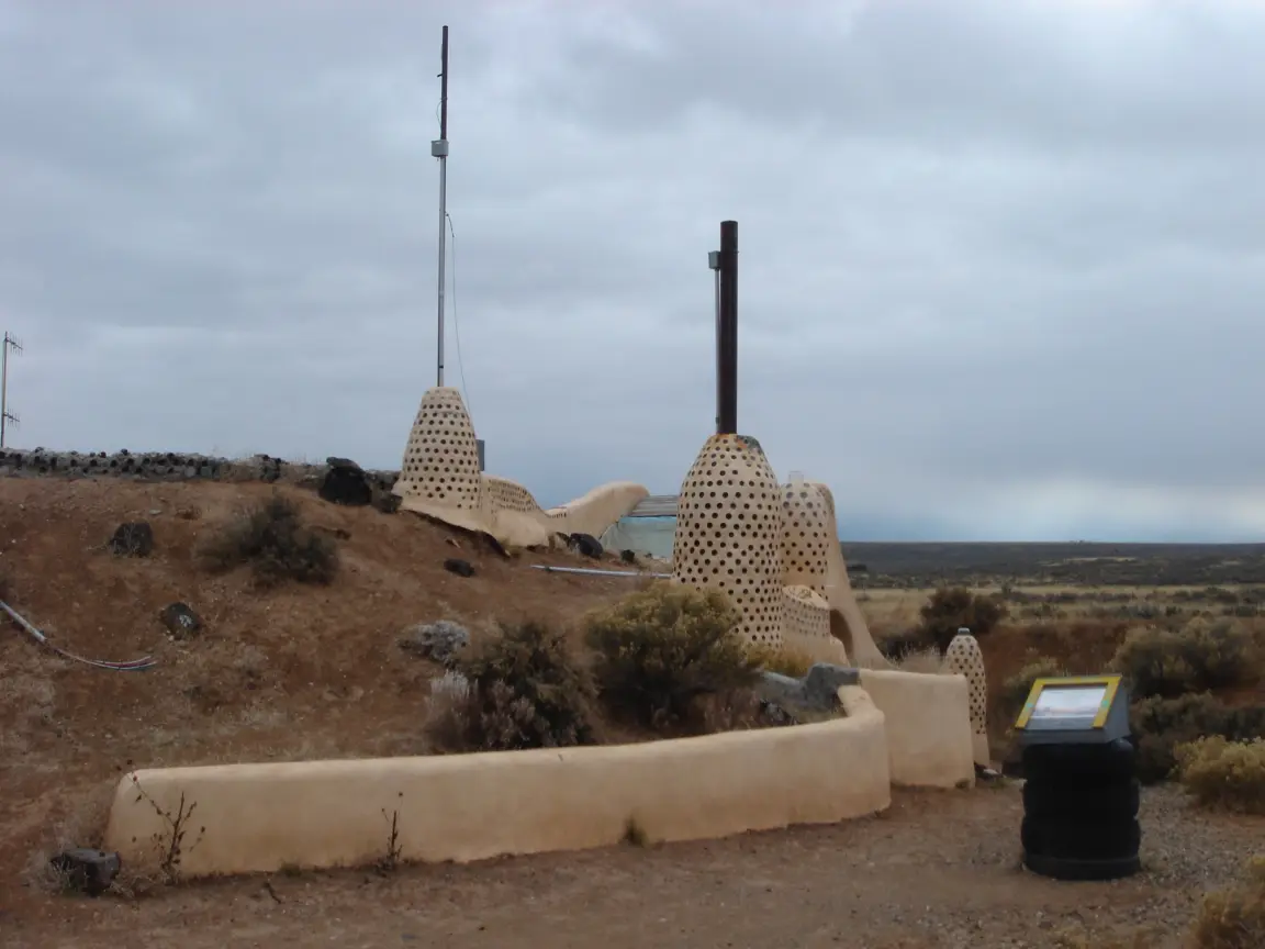 The Earthship community outside Taos, with Jess for scale.