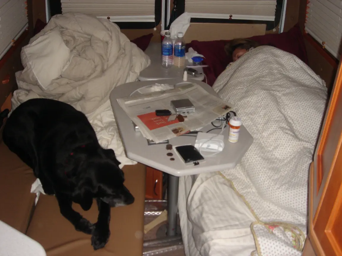 Morning at Iowa 80: Jess sleeping off her cold under every blanket we brought, Simon keeping watch from the other bed, and the two singles we were still learning to live with.