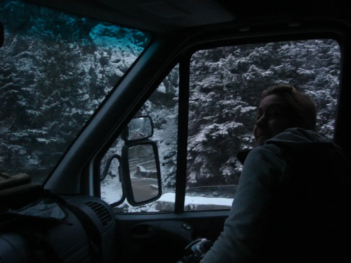 Snow closing in on the road toward Estes Park, and Simon keeping watch from his seat.