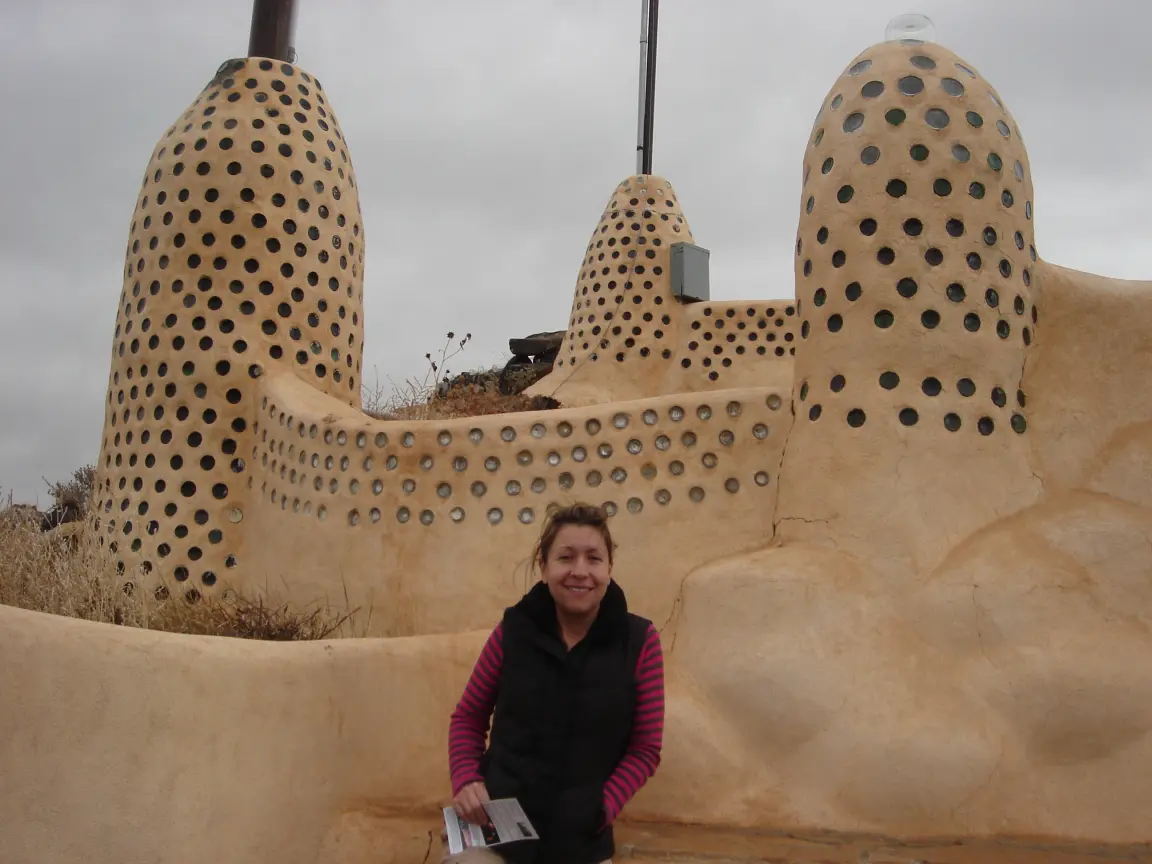 The Earthship community outside Taos, with Jess for scale.