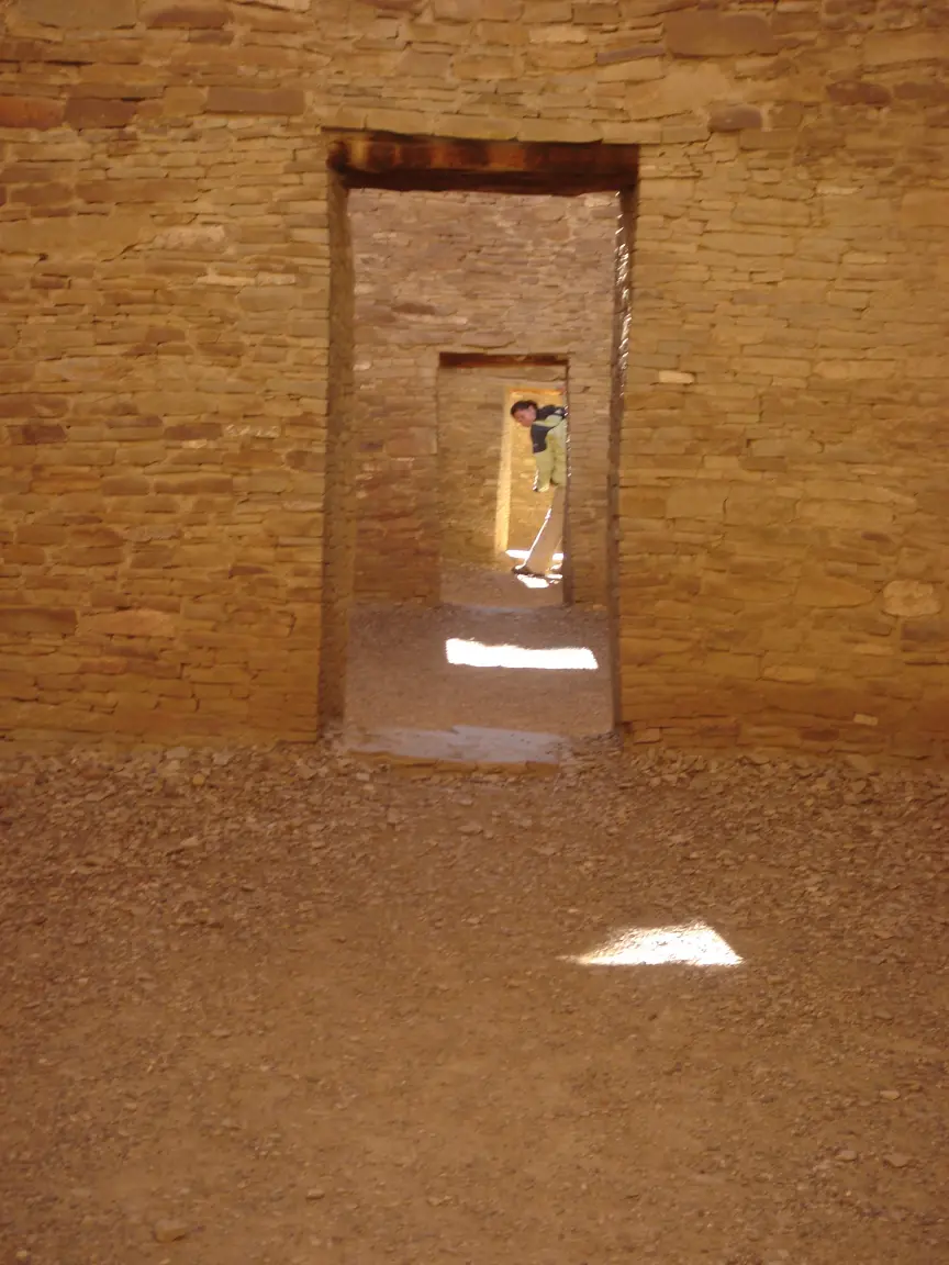 Jess in the doorways of Pueblo Bonito, one room deeper at a time.