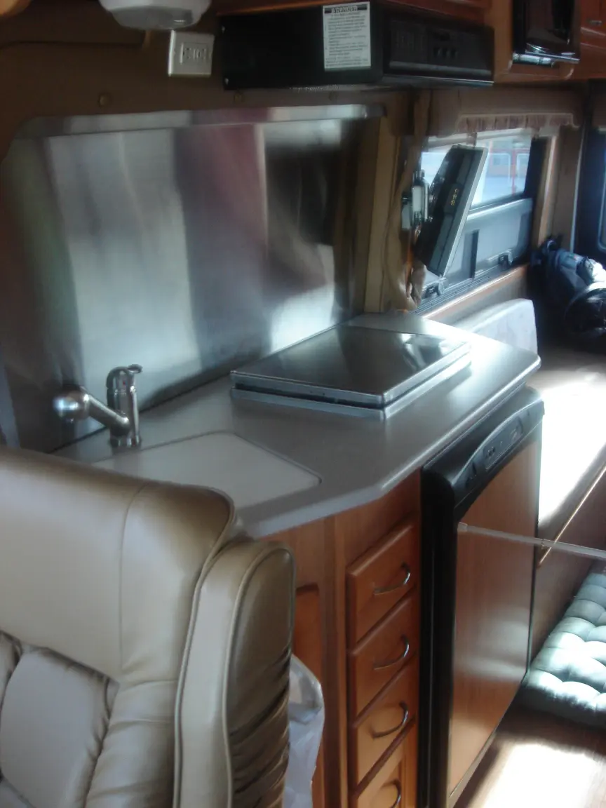 The van the day we brought it back: Simon's spot between the seats, the galley, the drawers, and every cabinet we learned to latch.