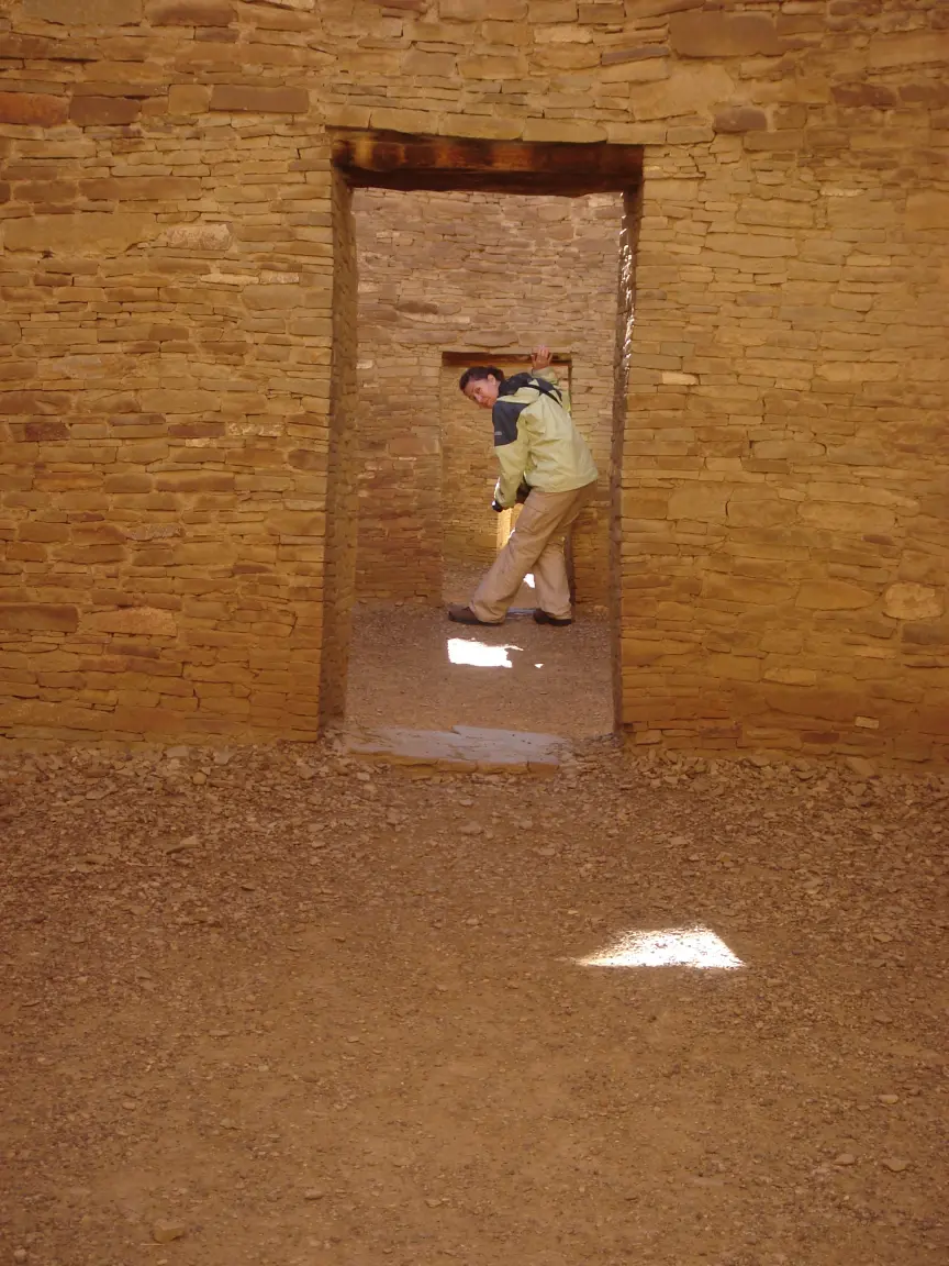 Jess in the doorways of Pueblo Bonito, one room deeper at a time.