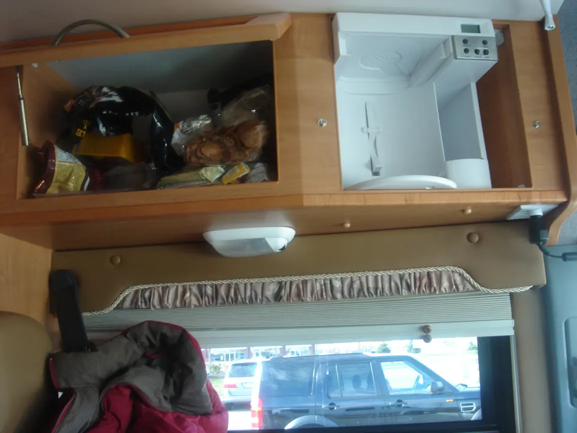 The van the day we brought it back: Simon's spot between the seats, the galley, the drawers, and every cabinet we learned to latch.