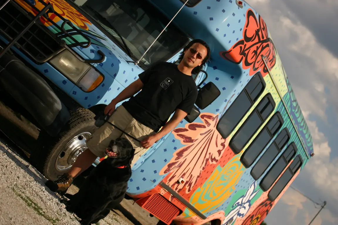 Sean and Simon in front of a hand-painted bus