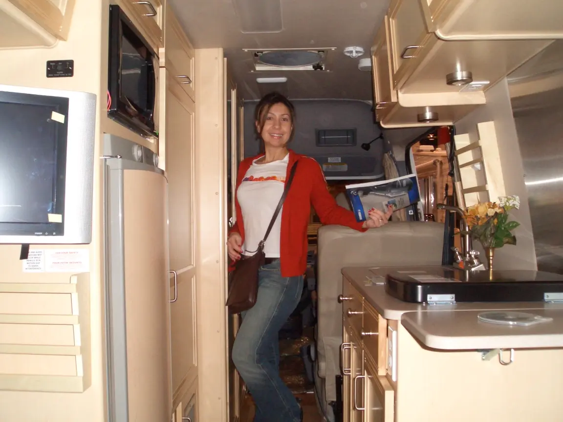Jess standing inside a Sprinter conversion at the RV show