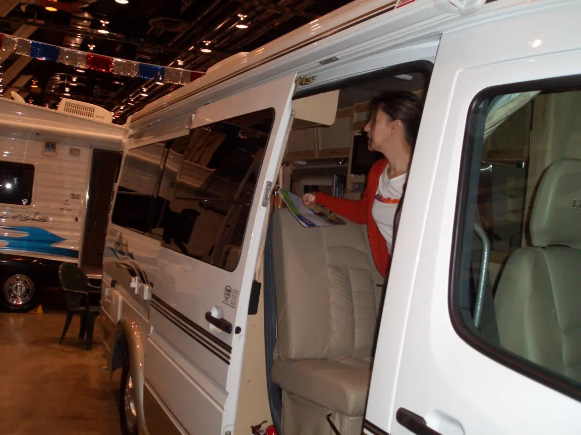 Jess at the side door of a camper van on the show floor