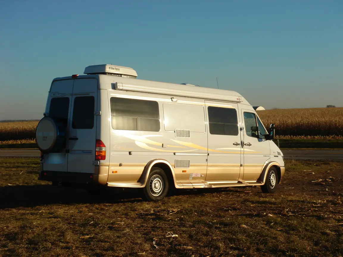 The rented Great West Van Sprinter parked beside a harvested cornfield